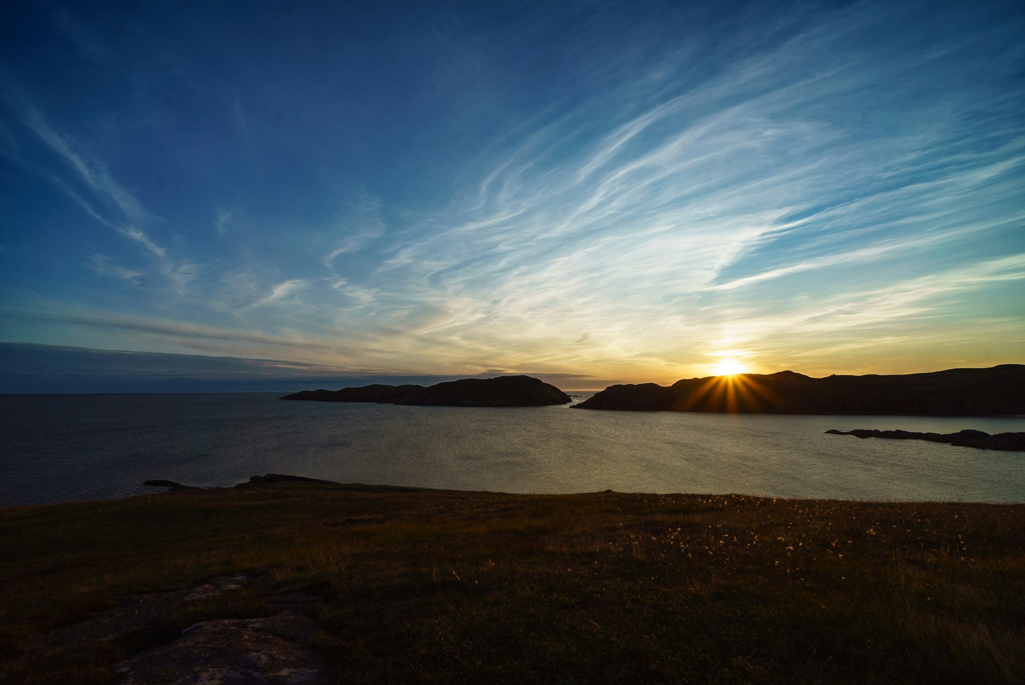 Golden sunset over a Highland sea loch at Clachtoll