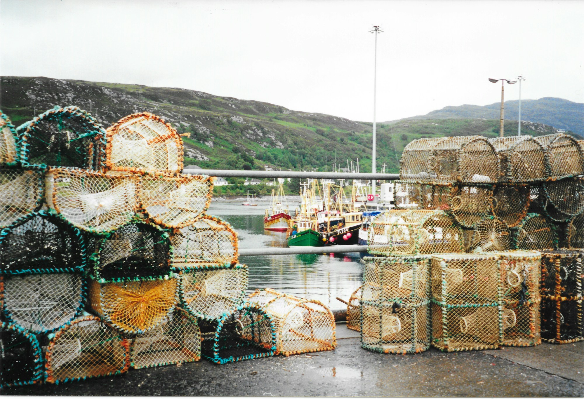 Lobster and crab creels stacked on the harbour at Ullapool